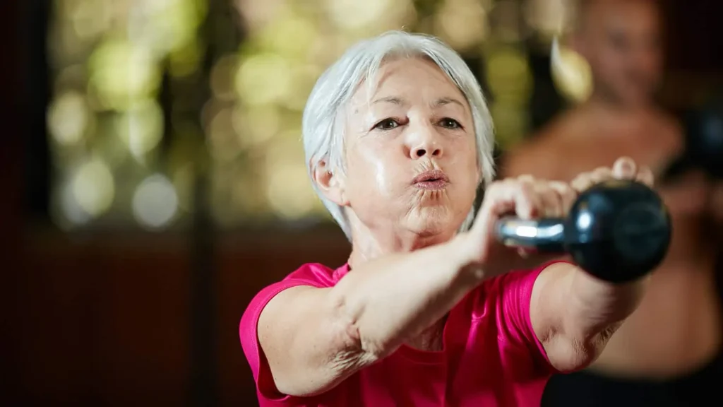 Toning Arms Without the Bulk: Is It Achievable? 1 Woman doing resistance band exercises for toned arms Billericay